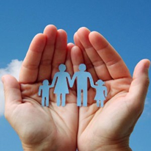 A person holding paper cut family members, symbolizing the bond and connection within a family